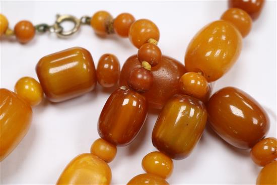A part amber bead necklace and a pair of amber bead earrings.